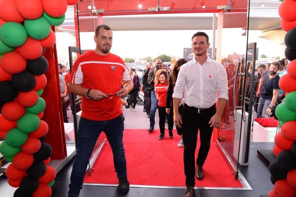 Filippo walking the red carpet through a balloon arch at a flagship store opening