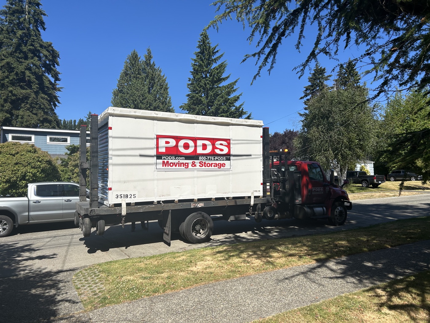 The PODS moving container on its truck outside the house